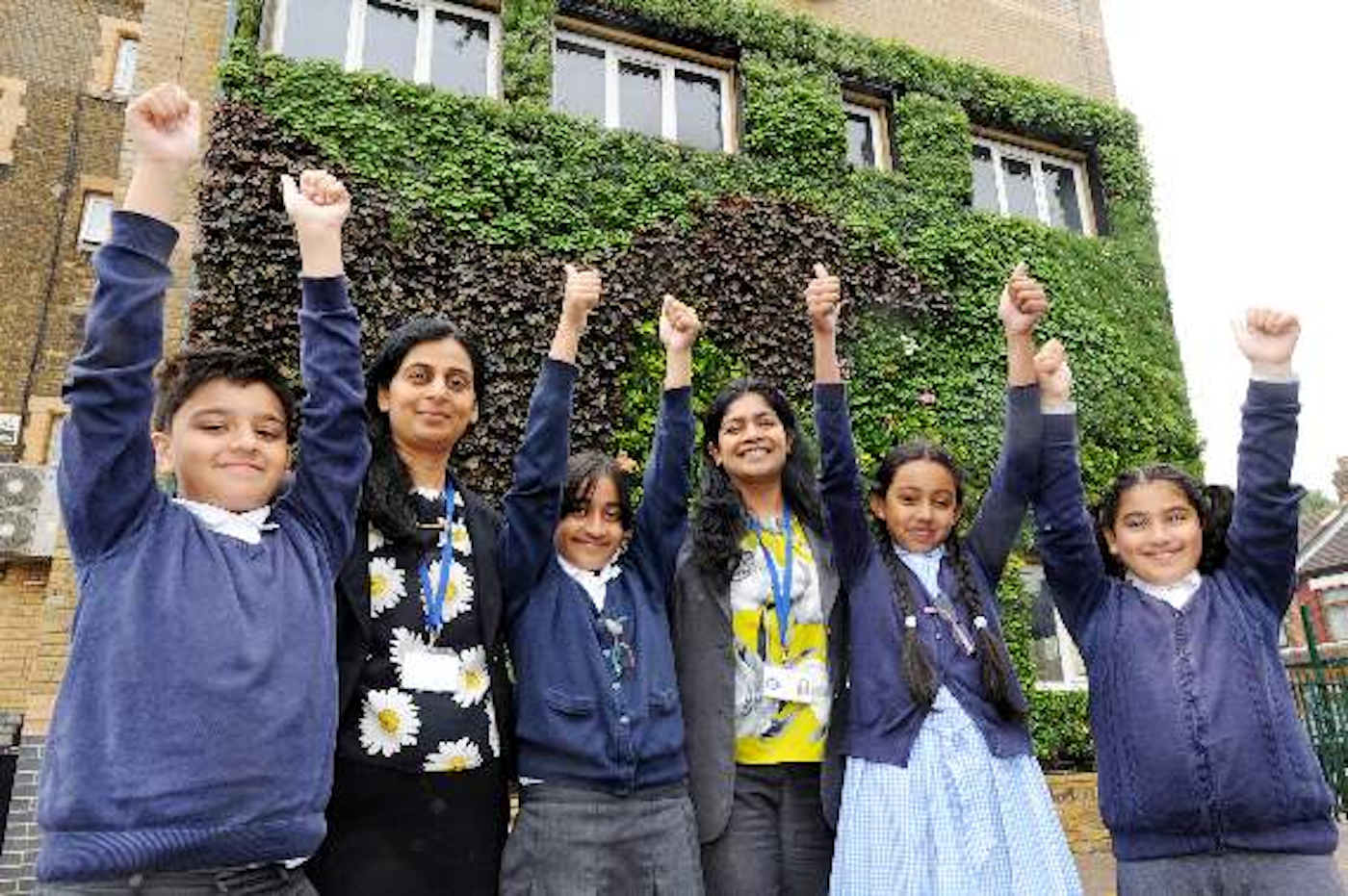 children in front of their schools living wall