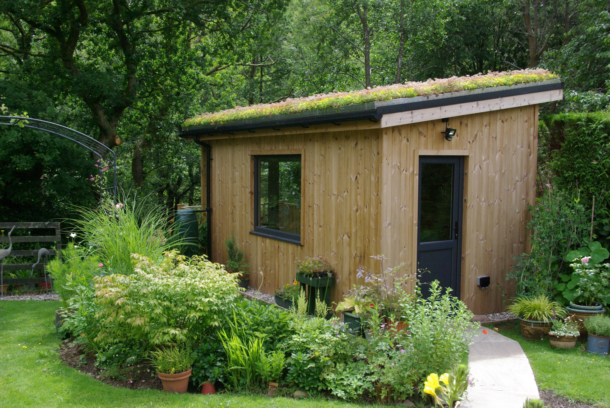garden cabin with wildflower green roof