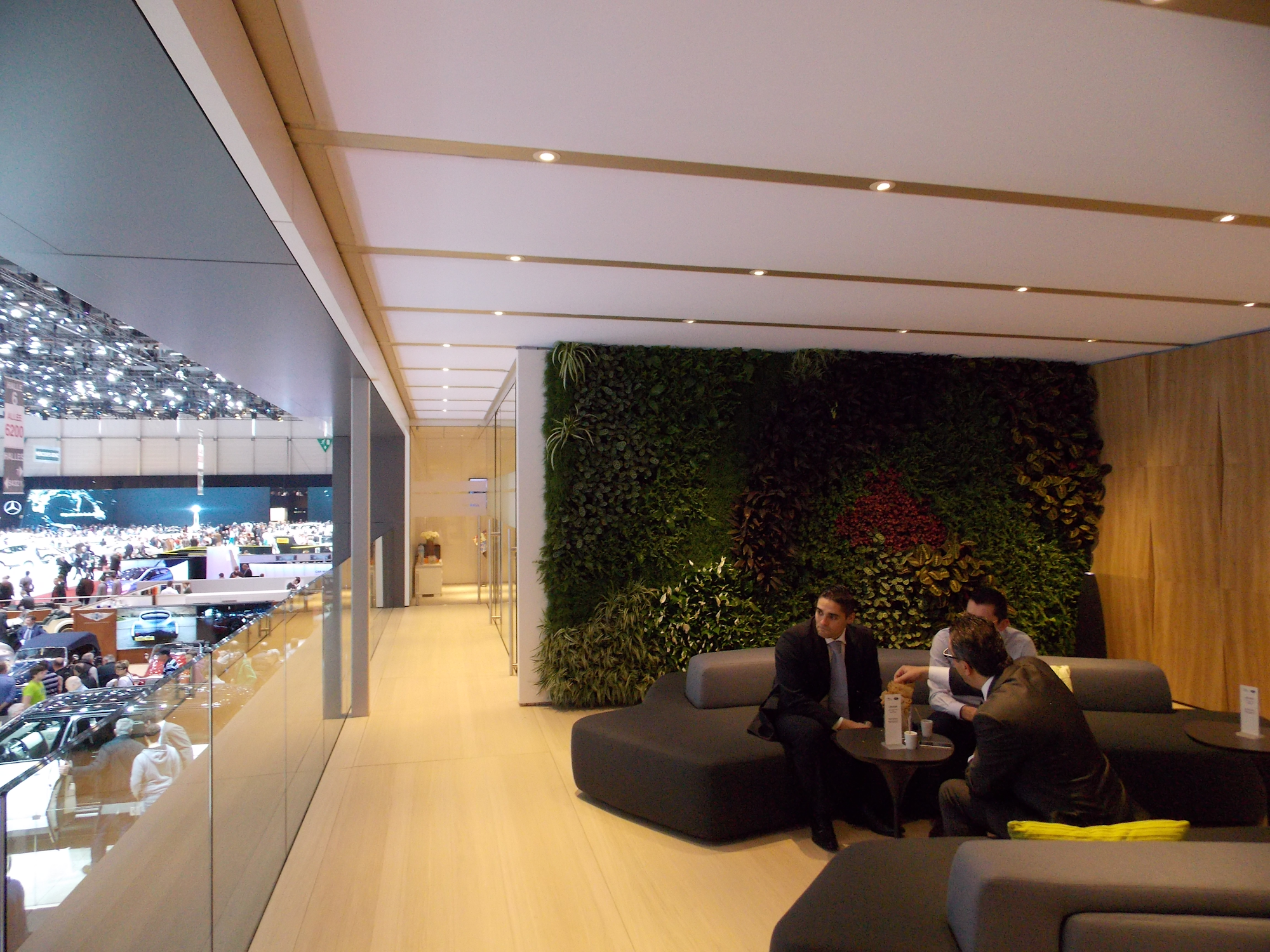 clients in a collaboration area having a meeting in front of an interior planted living wall