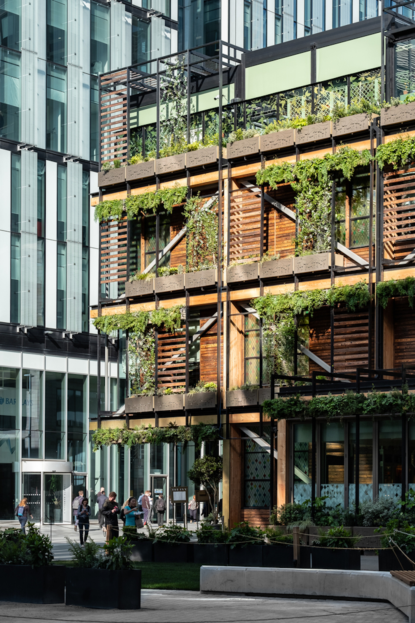 sustainable wood building covered in plants