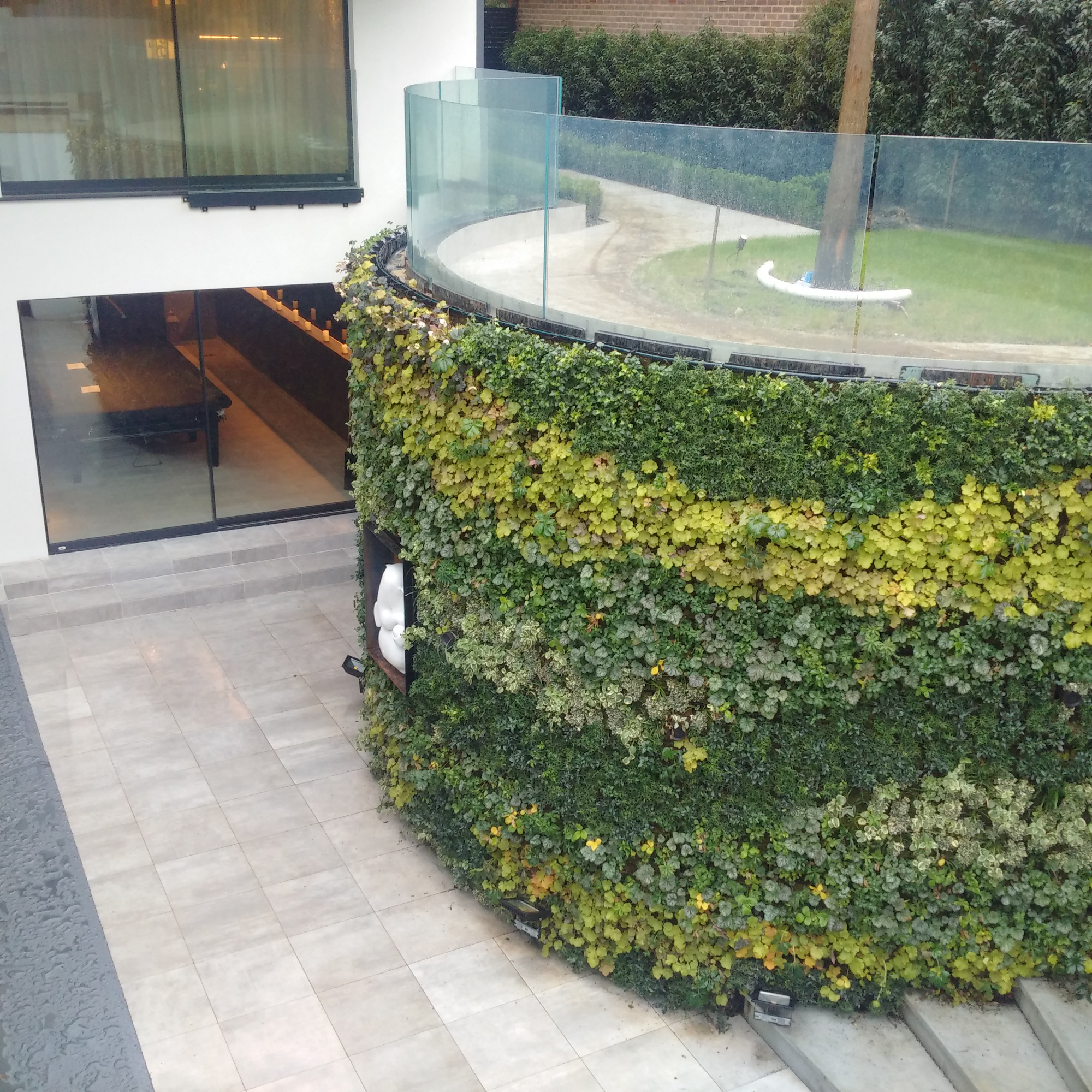 curved living wall in outdoor garden living area