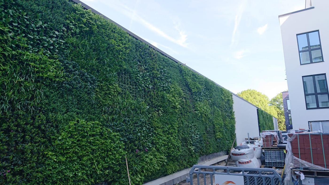 expansive green living wall on construction site