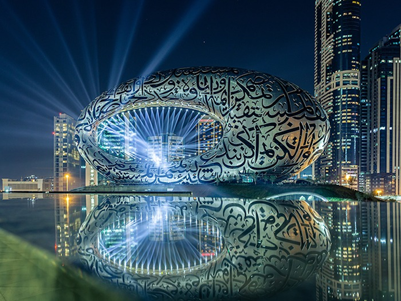 cityscape with strobe lights and metallic facade building with a lake in the foreground