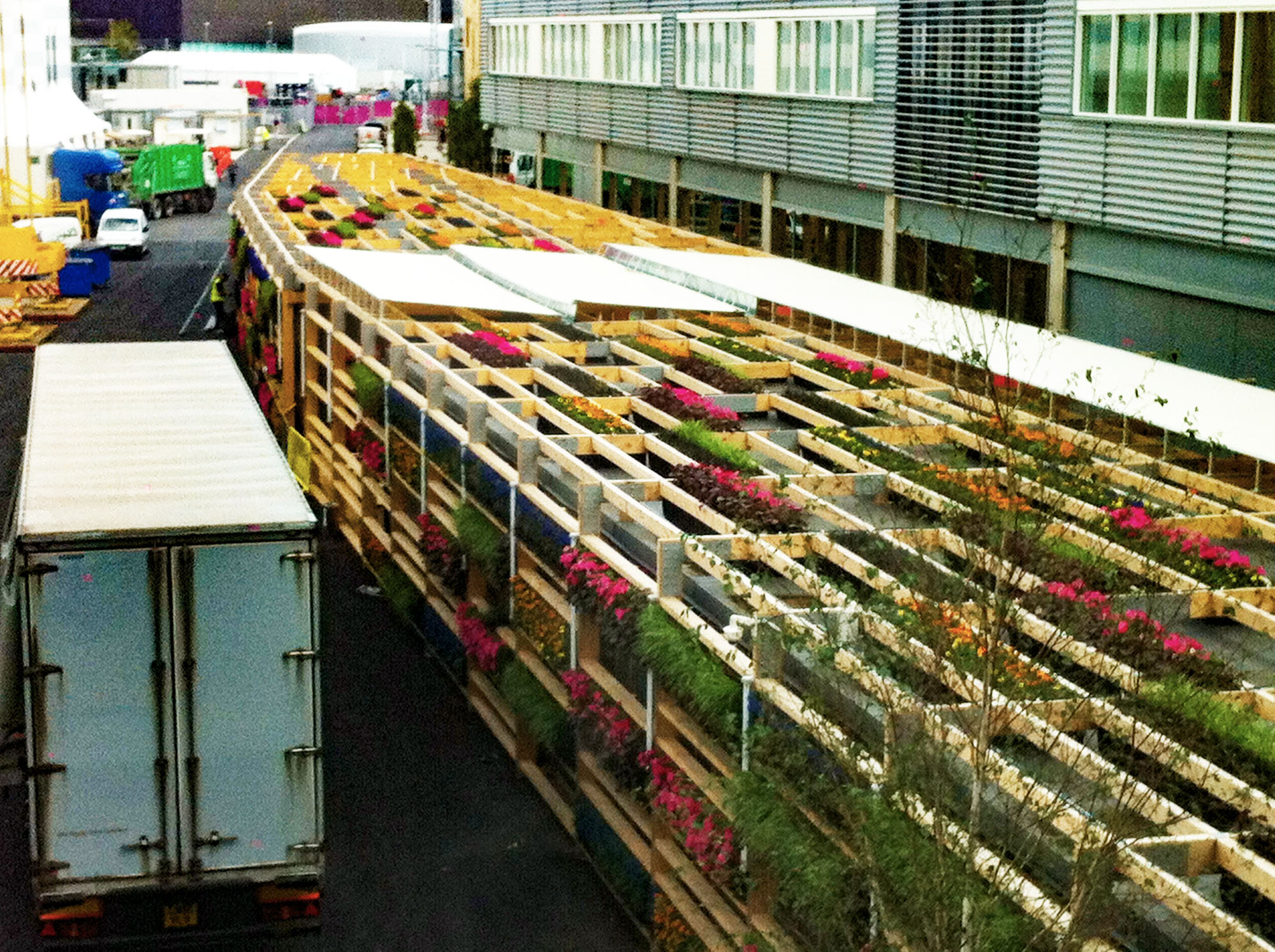 flowering green living wall modules installed along a purpose built timber structure