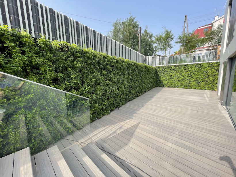 green vibrant living wall from staircase wrapping around garden decking