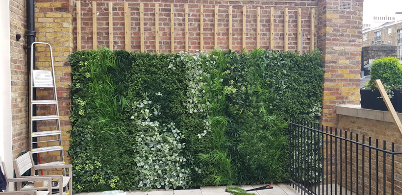 an artificial green wall being installed