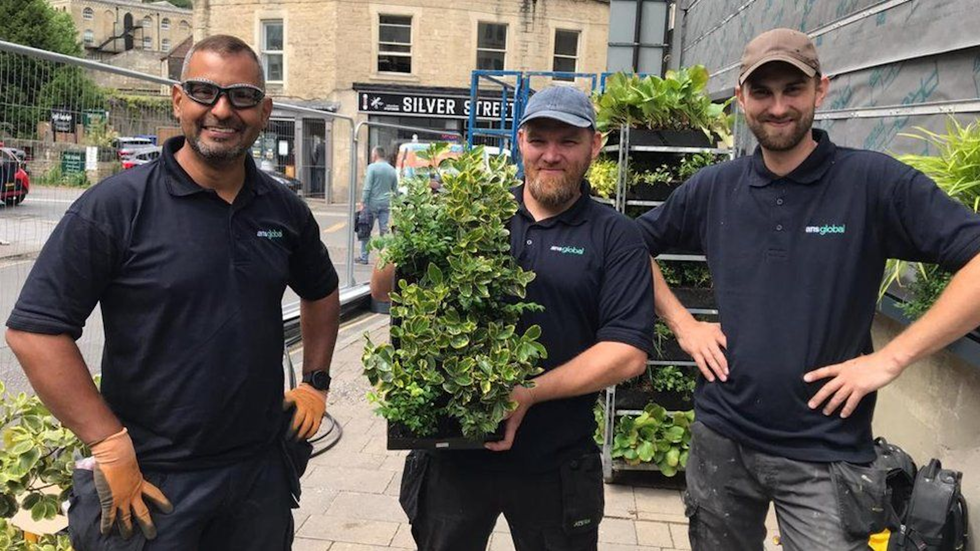 installation team holding a planted green wall module