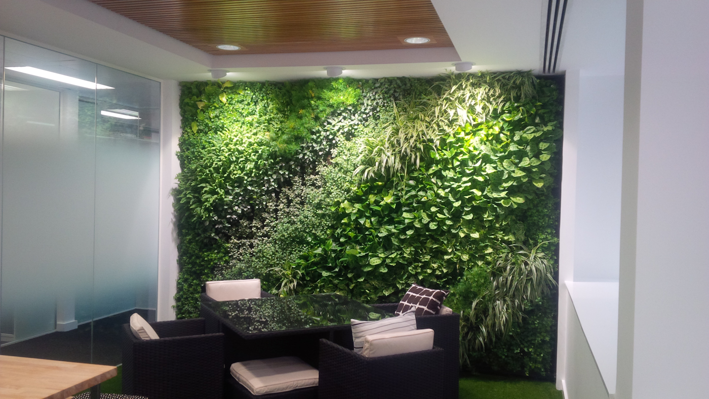 break out room in an office space with a living wall of interior plants