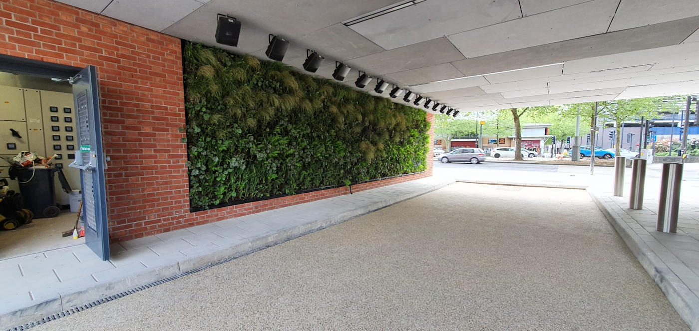 a living wall under a covered walkway at a hotel