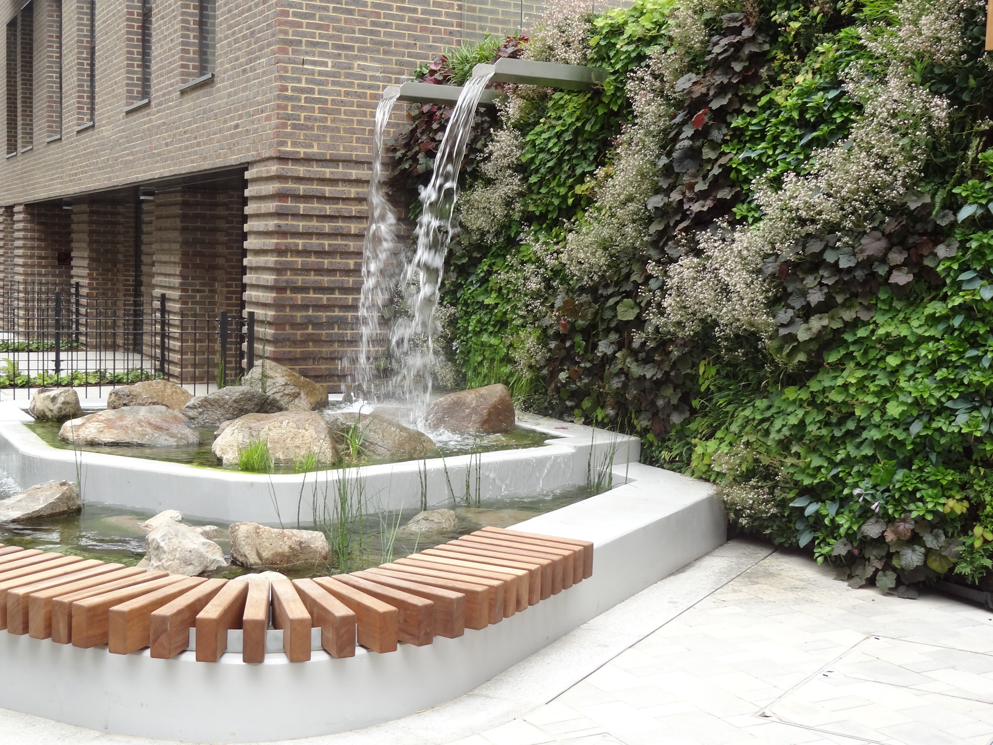 living wall with a waterfall feature and pond