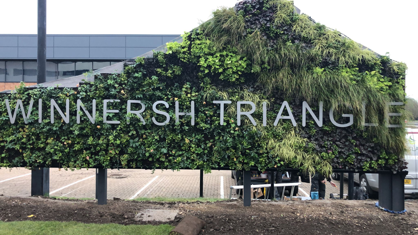 evergreen living wall with metal signage