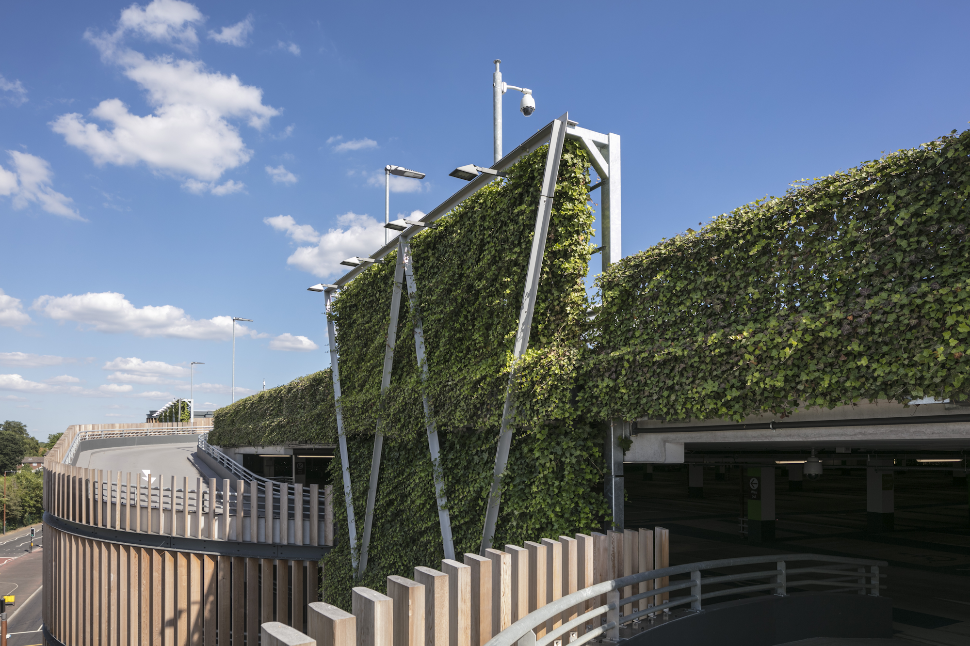 a car park with timber and planted facade